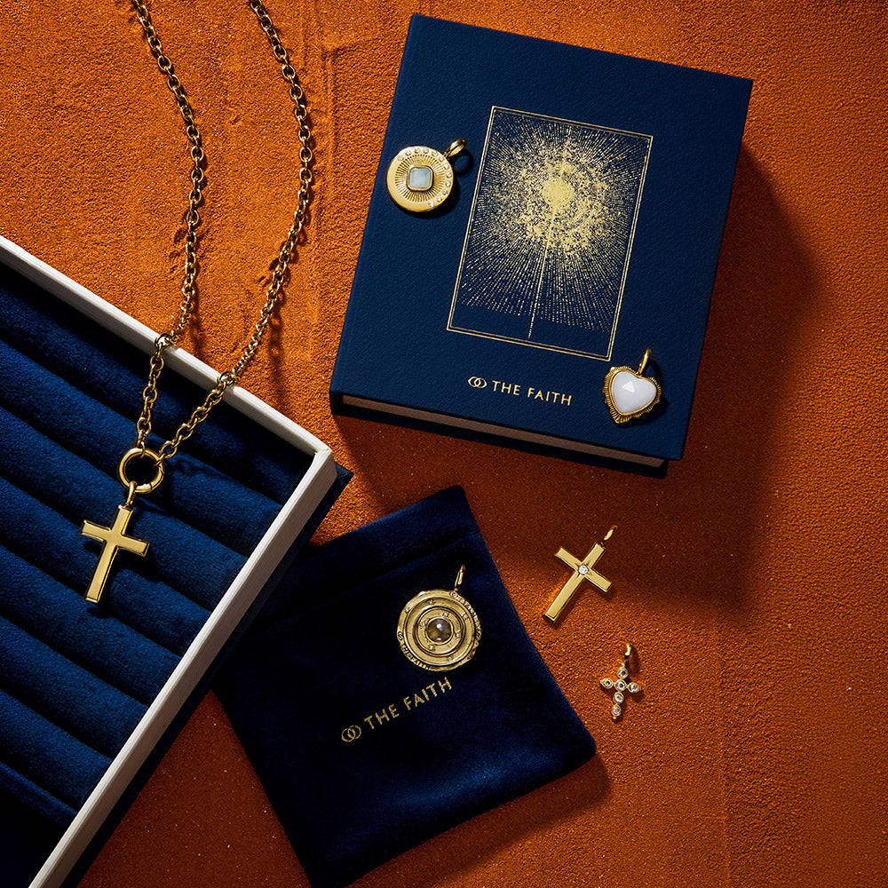 Bible gift box and velvet pouch for jewelry on textured orange-coloured surface.